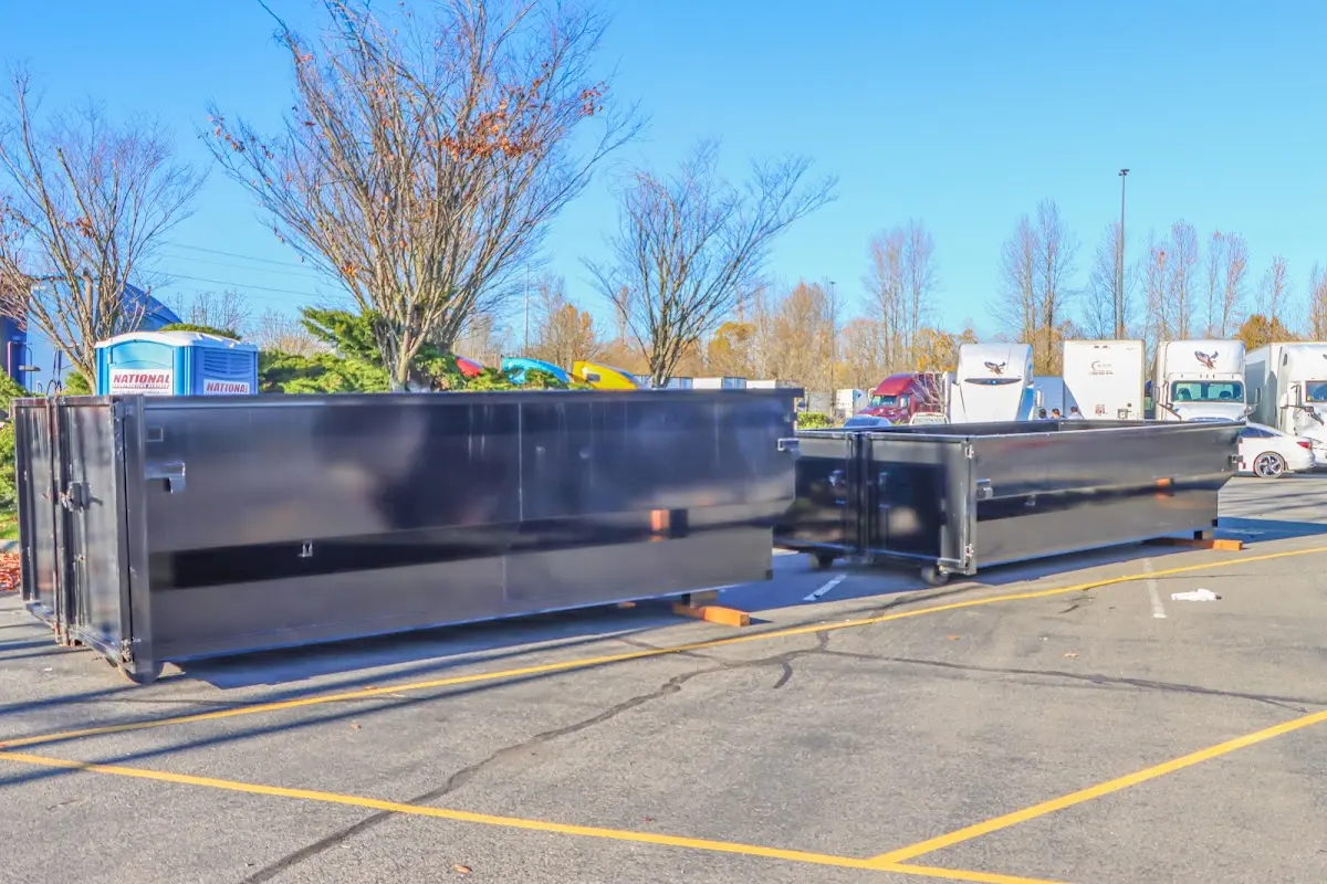 Professional dumpster rental service with roll-off container on residential driveway in Weymouth Town